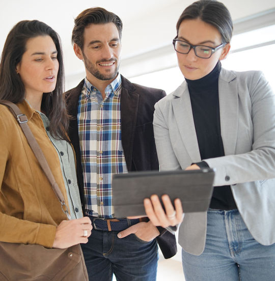 Real estate agent showing modern house to attractive couple